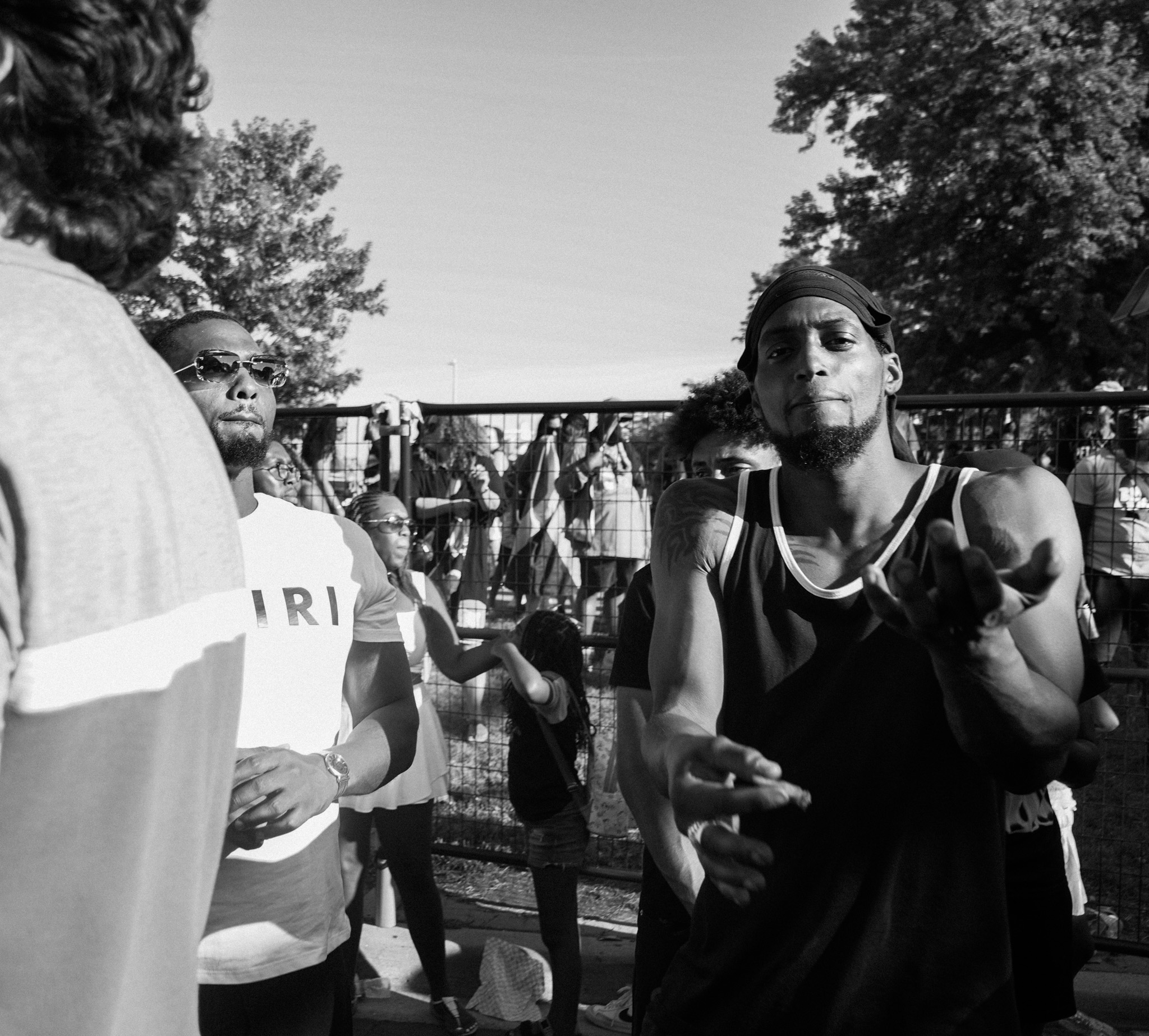 Men dancing and gesturing at an outdoor event