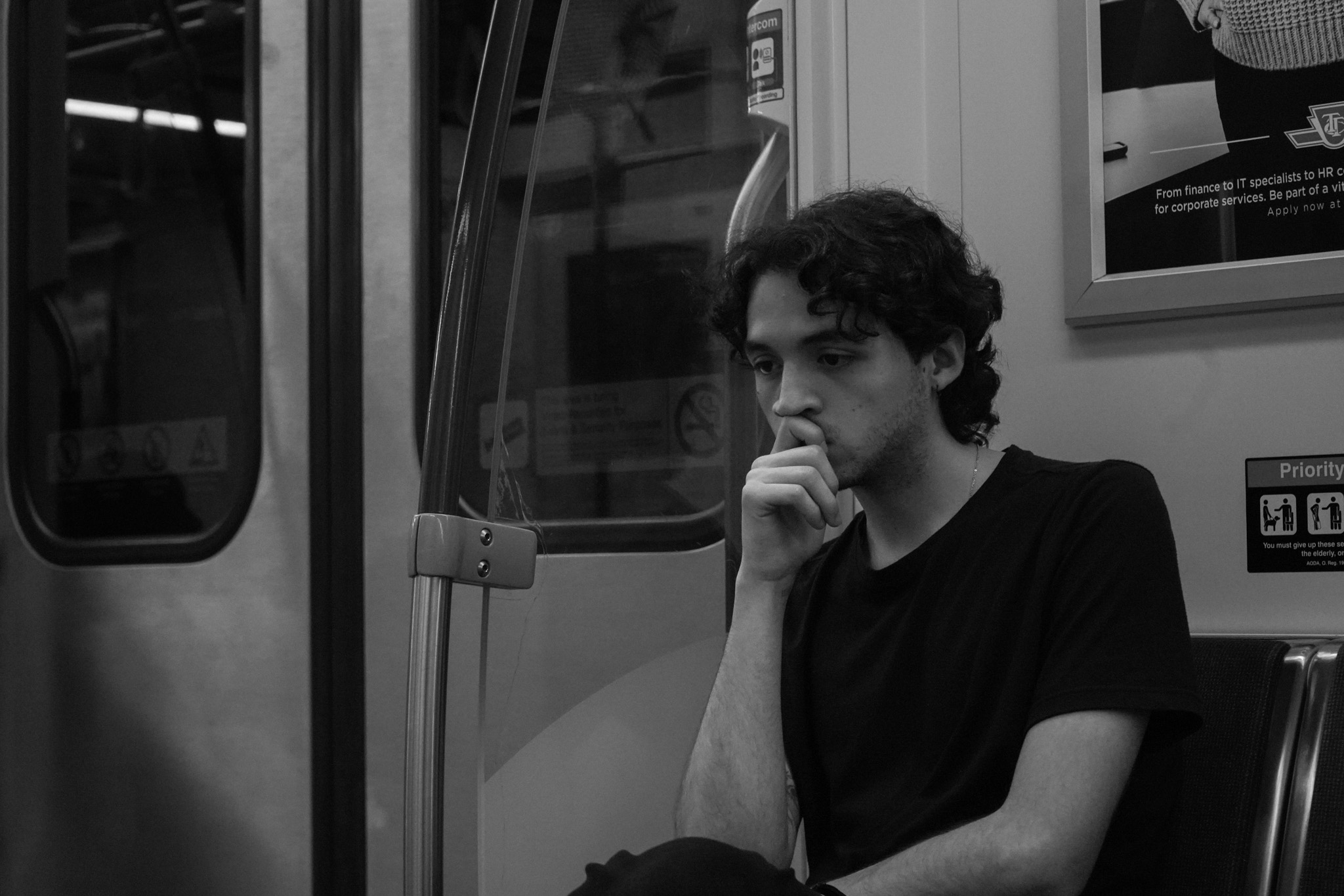 Man alone on the train, lost in thought