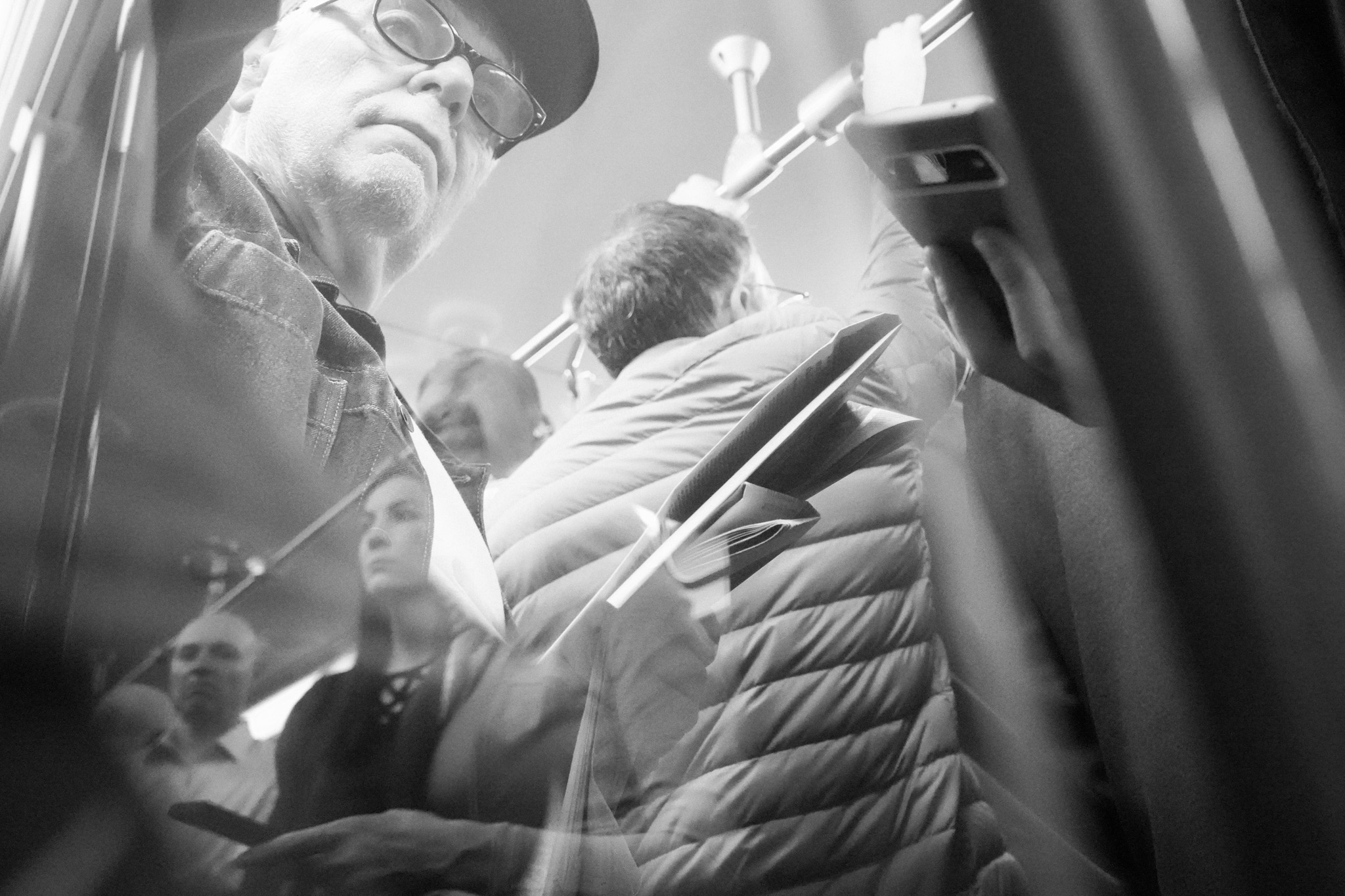 Young person watching through glass reflection